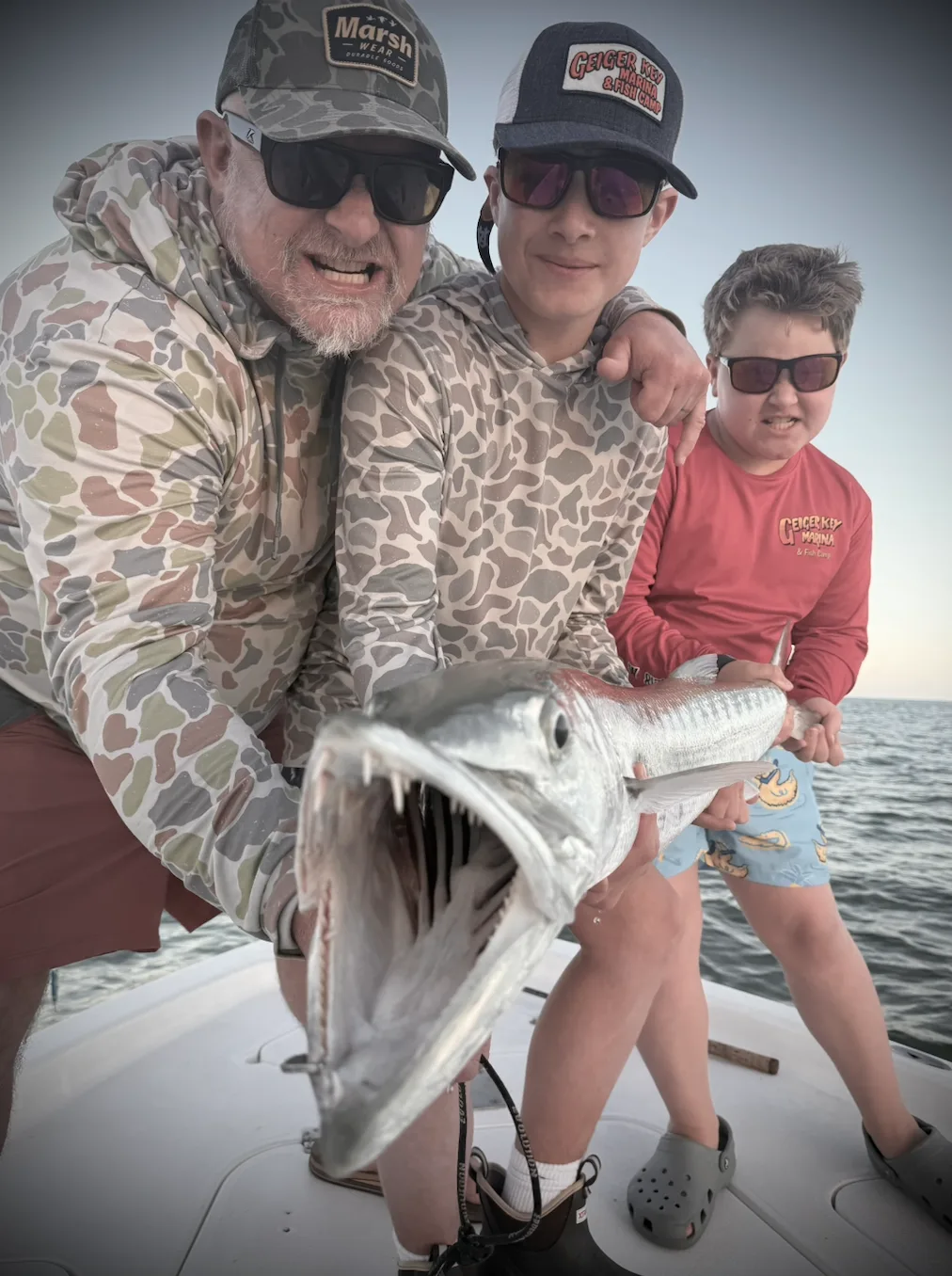Family holding a catch aboard a boat