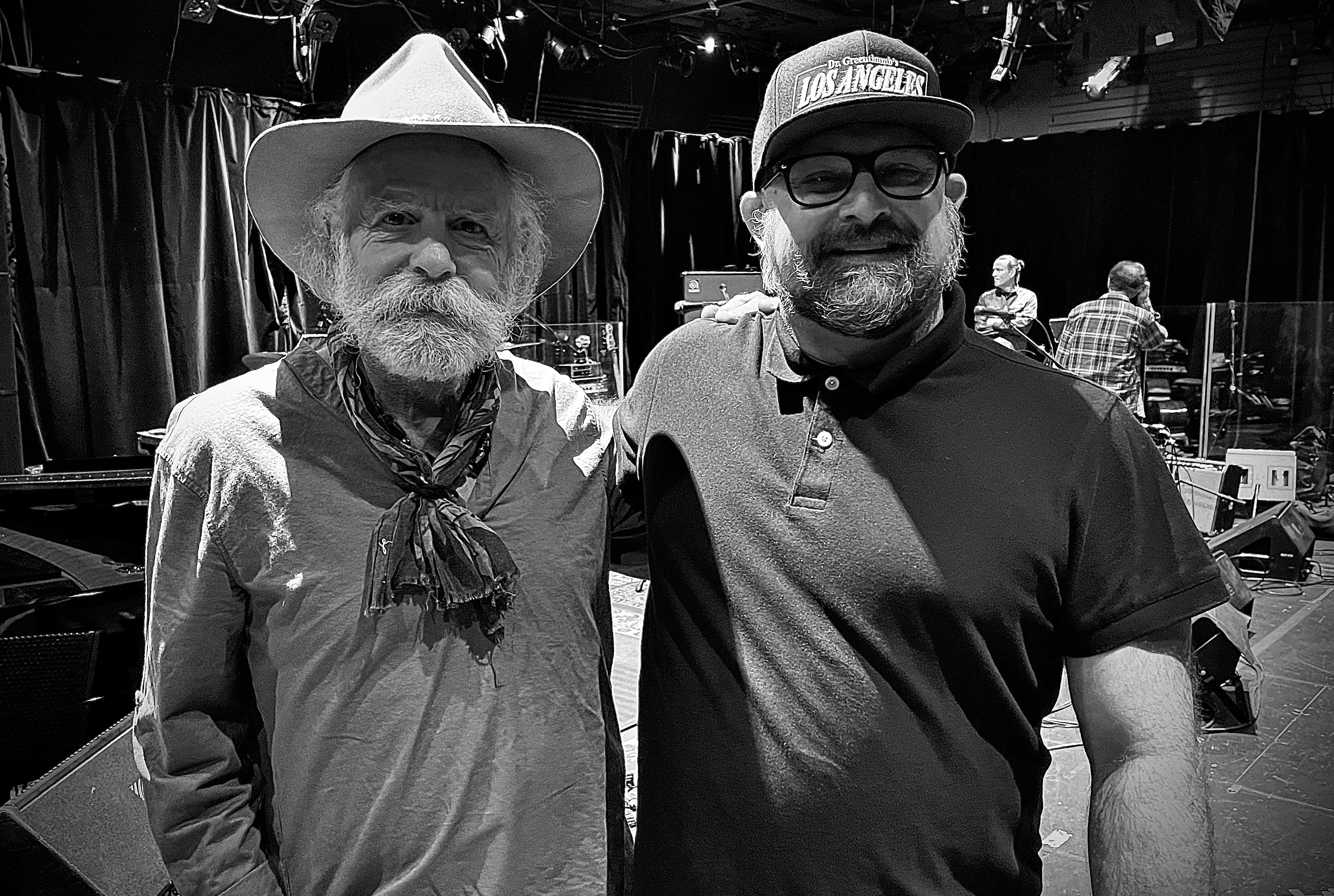Black-and-white backstage portrait of Vincent Adam Paul with a crew member