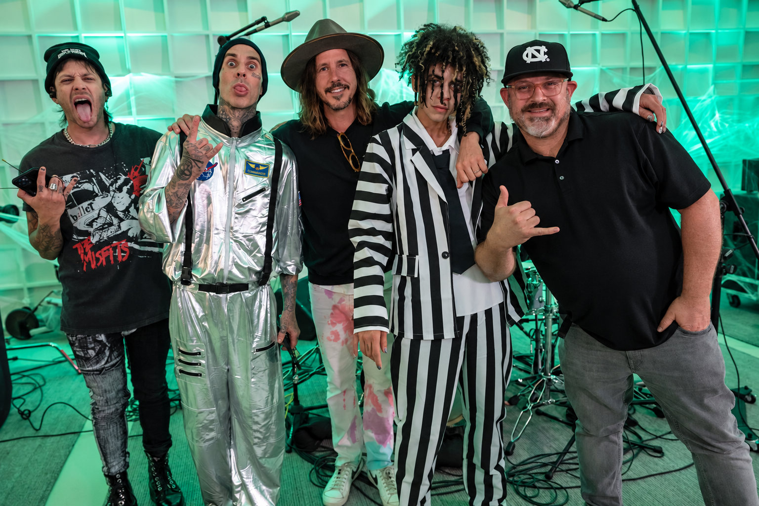 Musicians and crew gathered in a green-lit studio